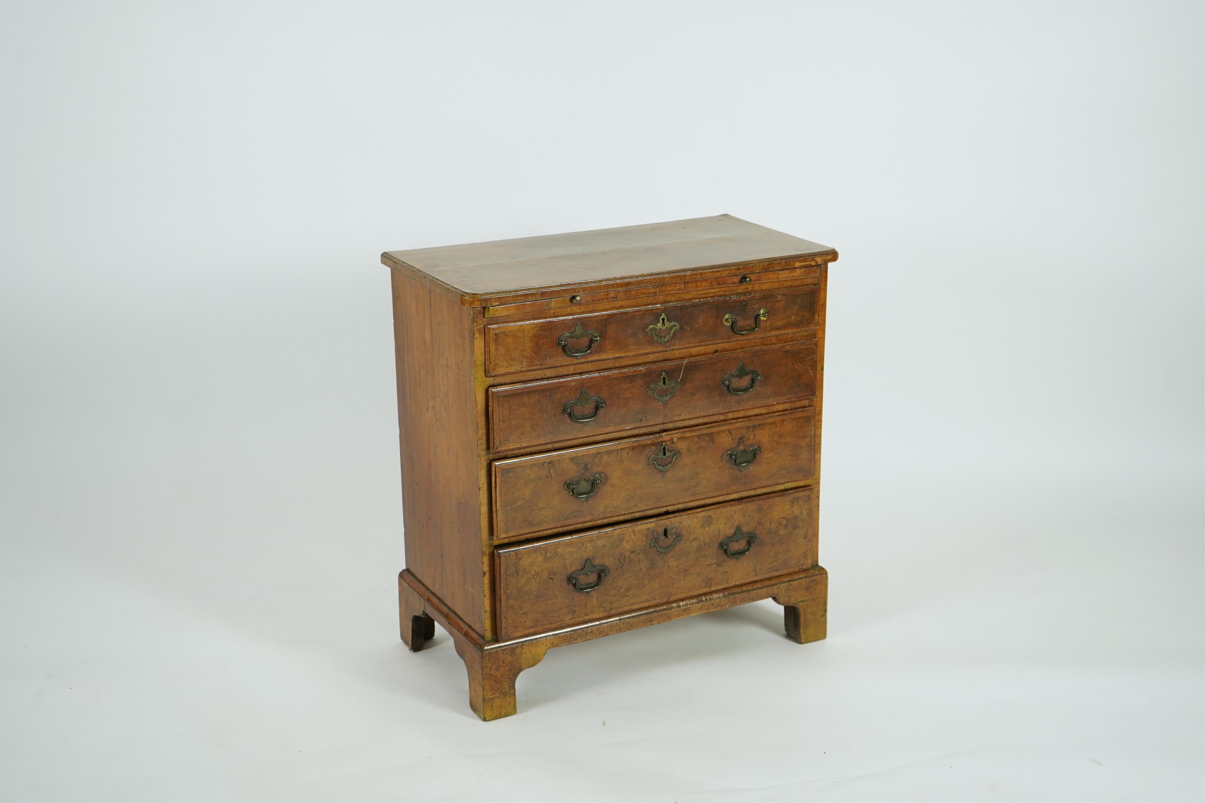 A small early 18th century and later cross and feather banded walnut veneered chest